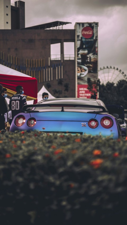 a car with a crowd of people around it