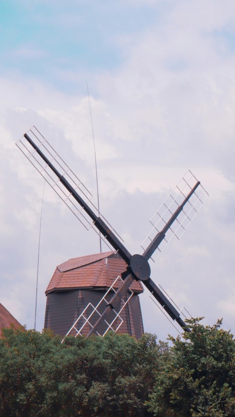 black and white windmill under white clouds