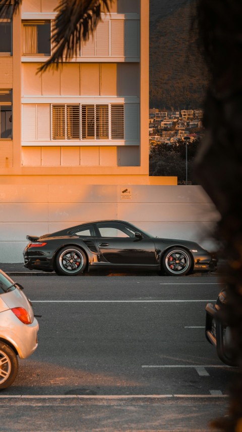 two cars parked in a parking lot next to a building