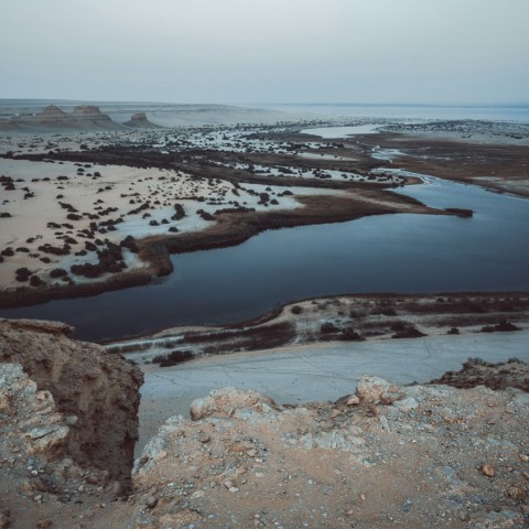 a large body of water surrounded by rocky terrain